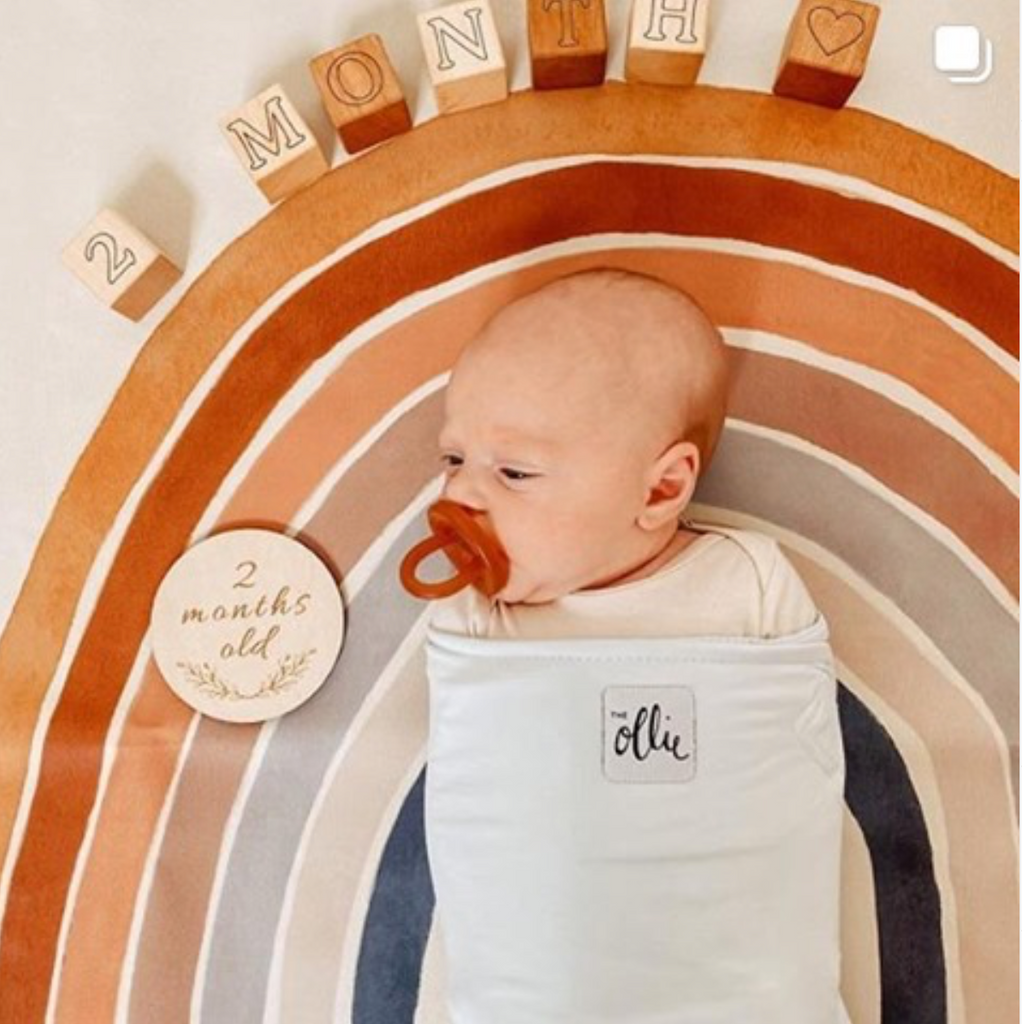 Q: My little one is going to turn 8 weeks. Can I continue to use the Ollie Swaddle past 8 weeks?
